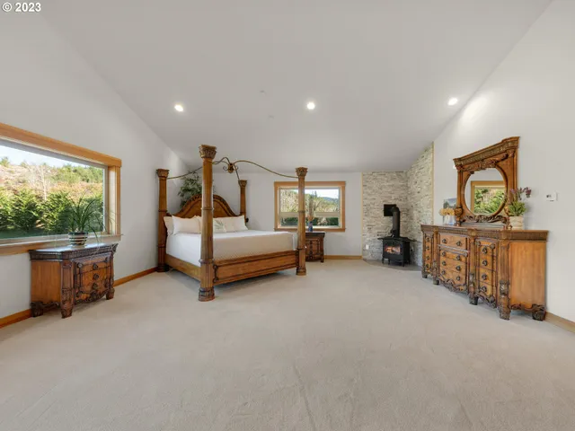 a spacious bedroom with a bed and a large window