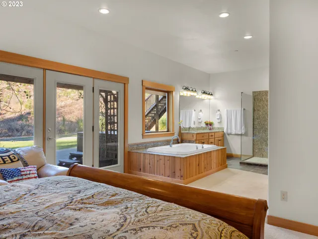 a bedroom with a large bed and a large window