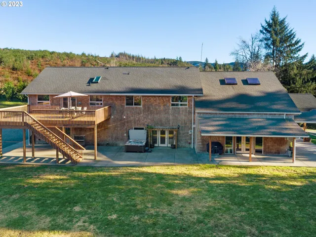 an aerial view of a house with swimming pool having outdoor seating