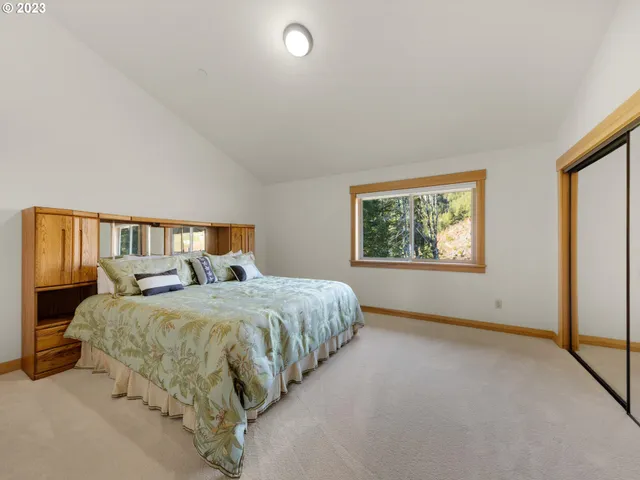 a bedroom with two beds and a window