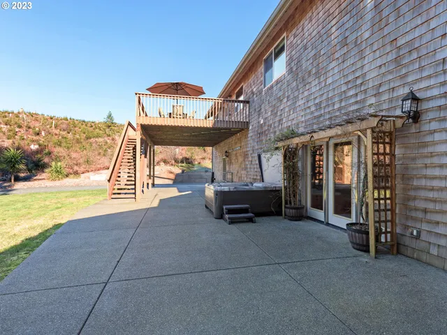 a view of a livingroom with furniture and floor to ceiling window