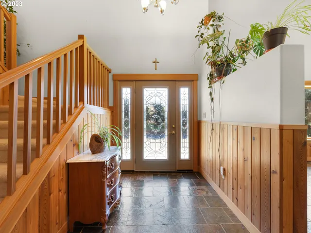a view of a hallway to a livingroom with furniture