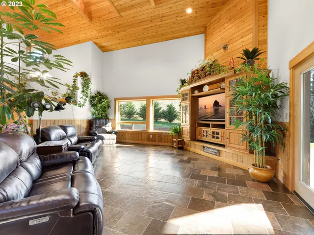a living room with patio furniture and a floor to ceiling window