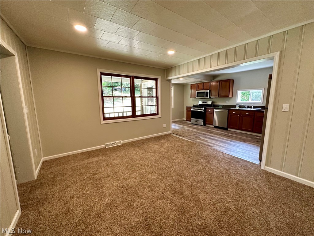 48963 Bloomfield Road East Liverpool, OH 43920 - Photo 11 of 25 Unfurnished living room with dark colored carpet and sink