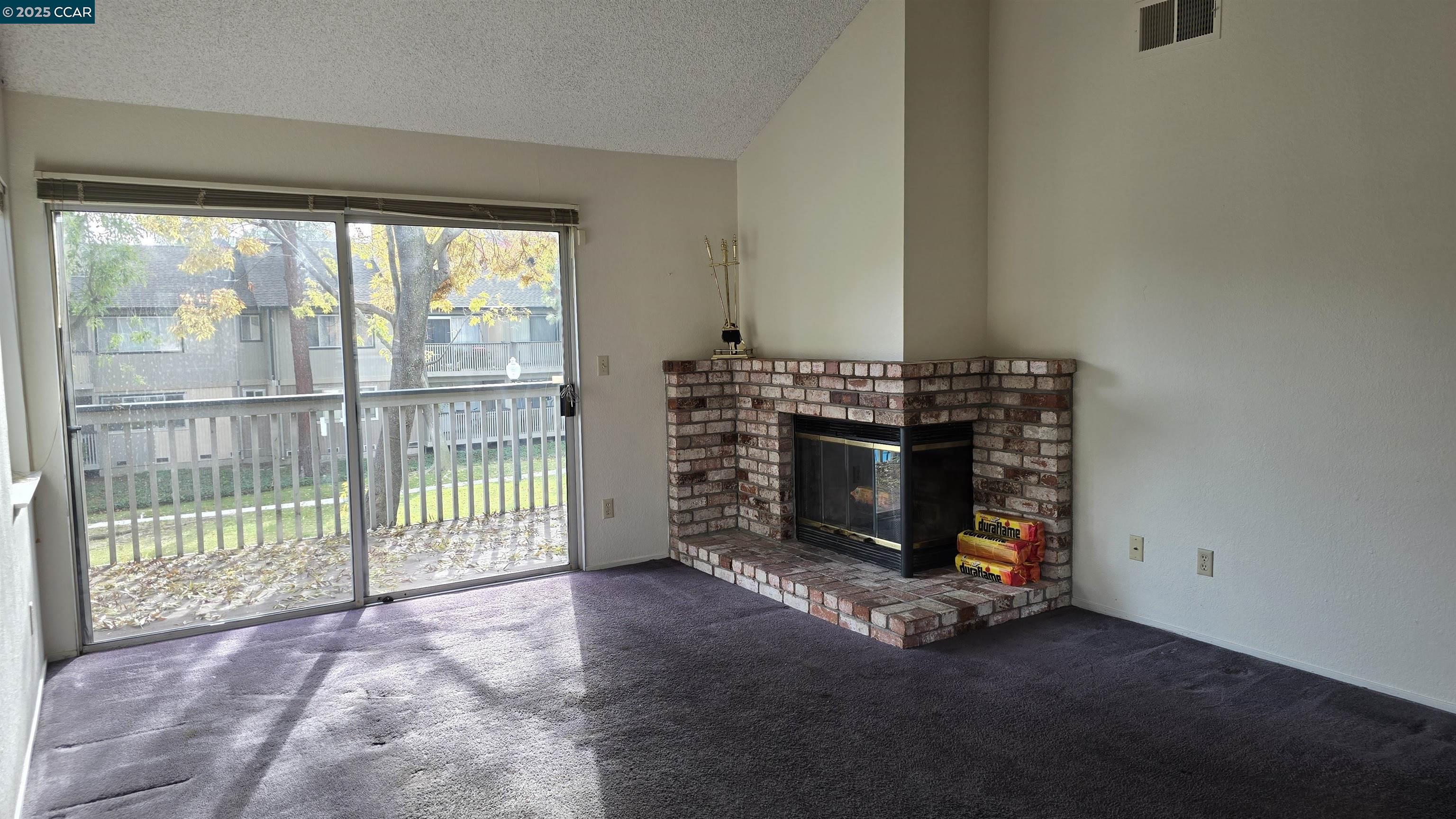 1123 Chadwick Circle Bay Point, CA 94565 - Photo 13 of 22 a living room with a fireplace and a large window