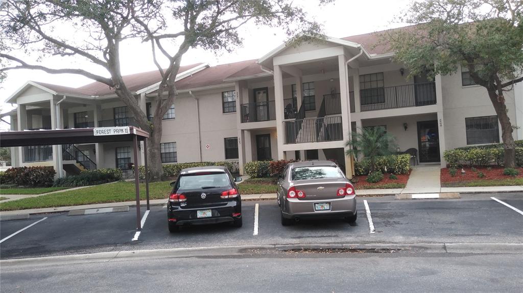 2163 Elm Street, Unit 803 Dunedin, FL 34698 - Photo 3 of 15 a car parked in front of a white house