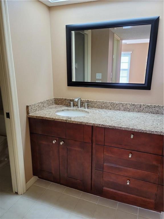 2163 Elm Street, Unit 803 Dunedin, FL 34698 - Photo 8 of 15 a bathroom with a sink vanity and mirror