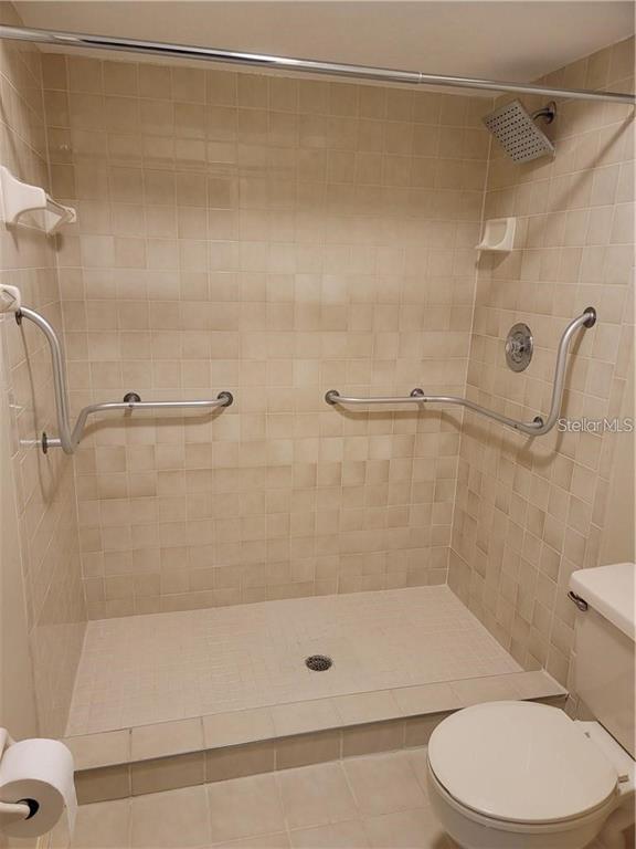 2163 Elm Street, Unit 803 Dunedin, FL 34698 - Photo 9 of 15 a bathroom with a shower and a toilet