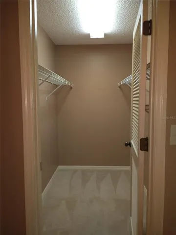 a bathroom with a granite countertop sink mirror vanity and a bathtub