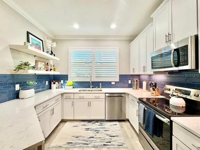 a kitchen with a sink stove top oven and cabinets