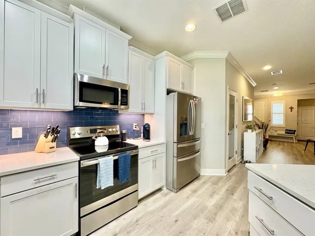 a kitchen with a refrigerator stove and microwave
