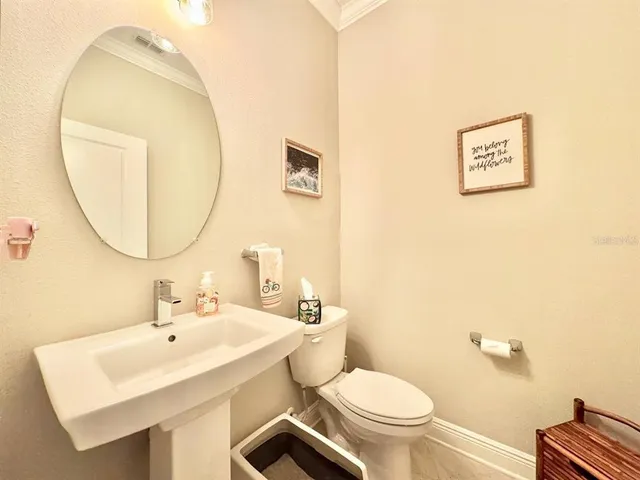 a bathroom with a sink a mirror and a toilet