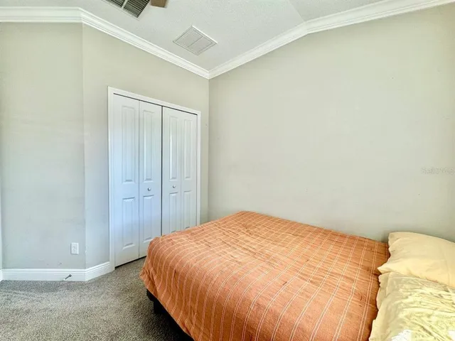 a bedroom with a bed and a wall painting