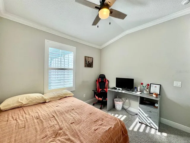 a bedroom that has a bed and a desk