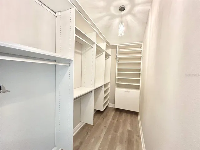 a view of walk in closet with empty racks