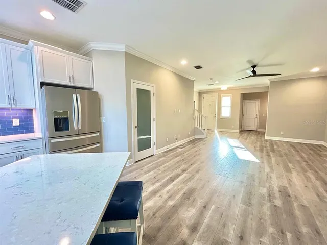 a view of a refrigerator in kitchen and wooden floor