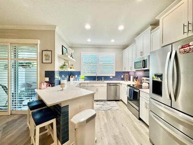 a large kitchen with a table and chairs