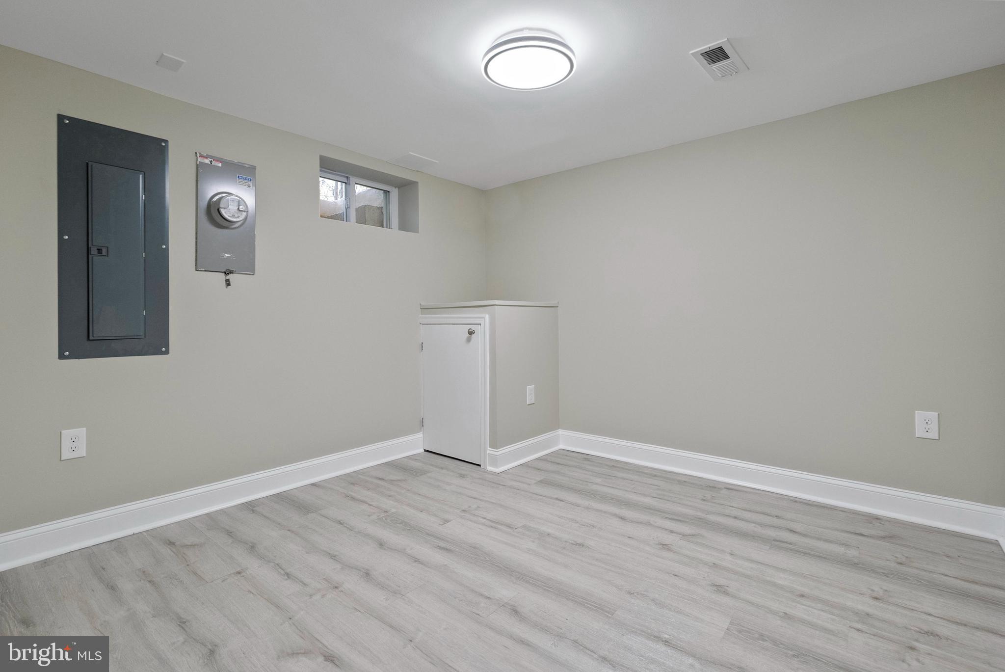 1641 Northwick Road Baltimore, MD 21218 - Photo 19 of 24 an empty room with wooden floor and windows