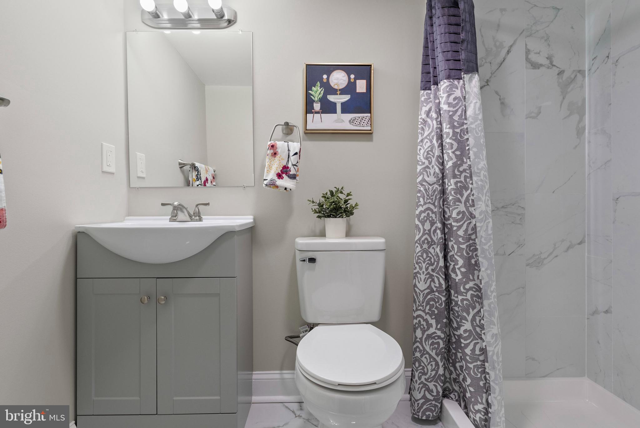 1641 Northwick Road Baltimore, MD 21218 - Photo 20 of 24 a bathroom with a sink toilet and a mirror