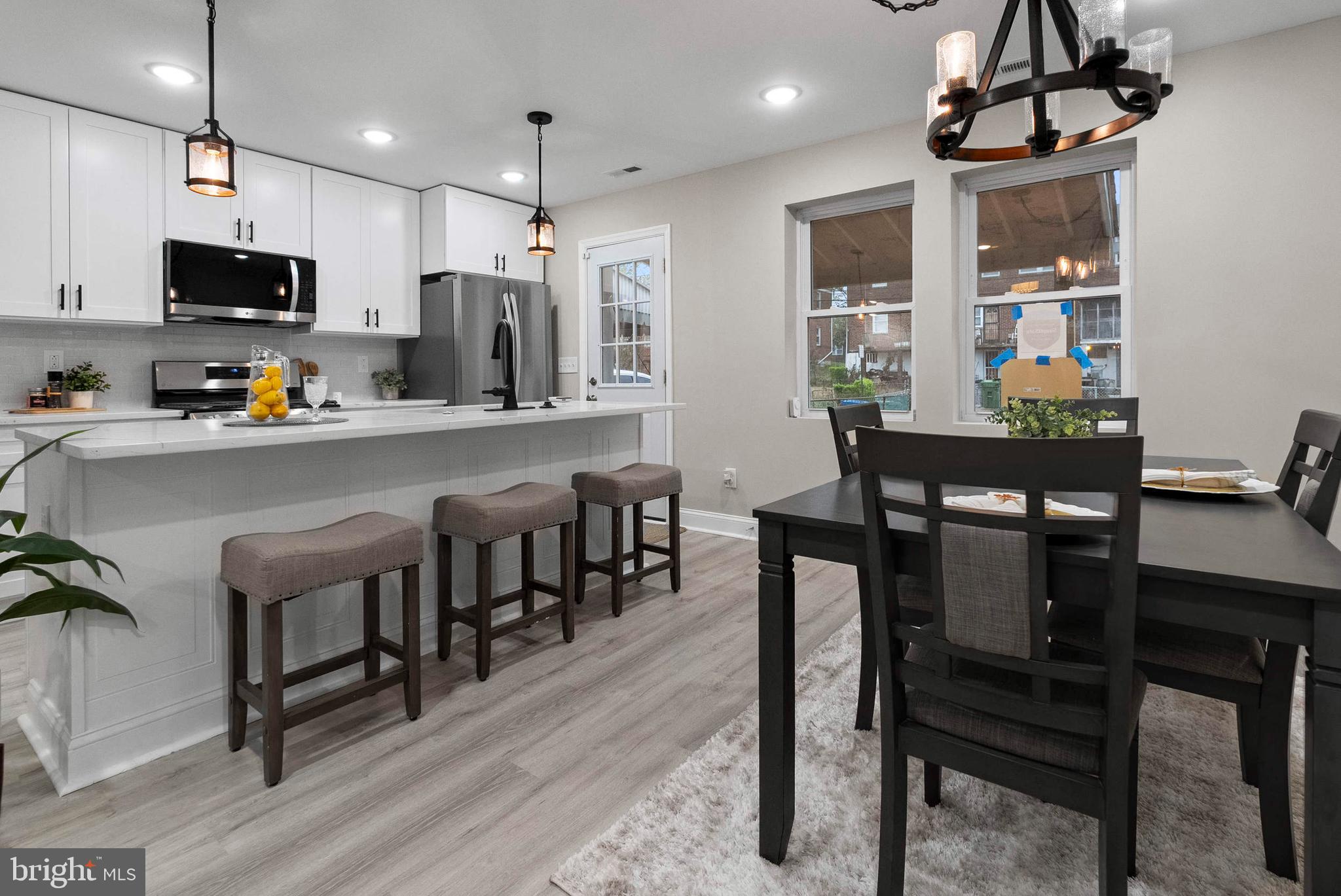 1641 Northwick Road Baltimore, MD 21218 - Photo 5 of 24 a kitchen with stainless steel appliances a dining table chairs microwave and sink