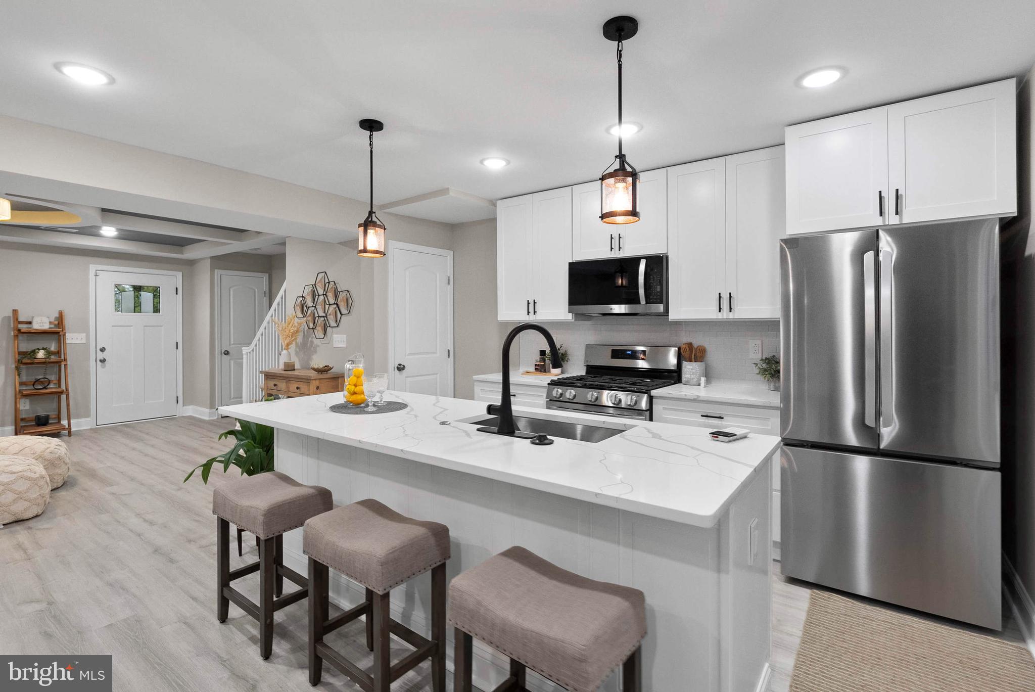 1641 Northwick Road Baltimore, MD 21218 - Photo 6 of 24 a kitchen with stainless steel appliances a stove a refrigerator a sink a center island a stove and a center island