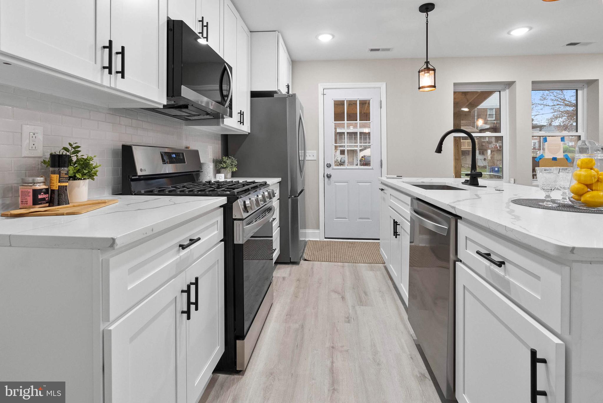 1641 Northwick Road Baltimore, MD 21218 - Photo 7 of 24 a kitchen with stainless steel appliances granite countertop a sink a stove and a refrigerator