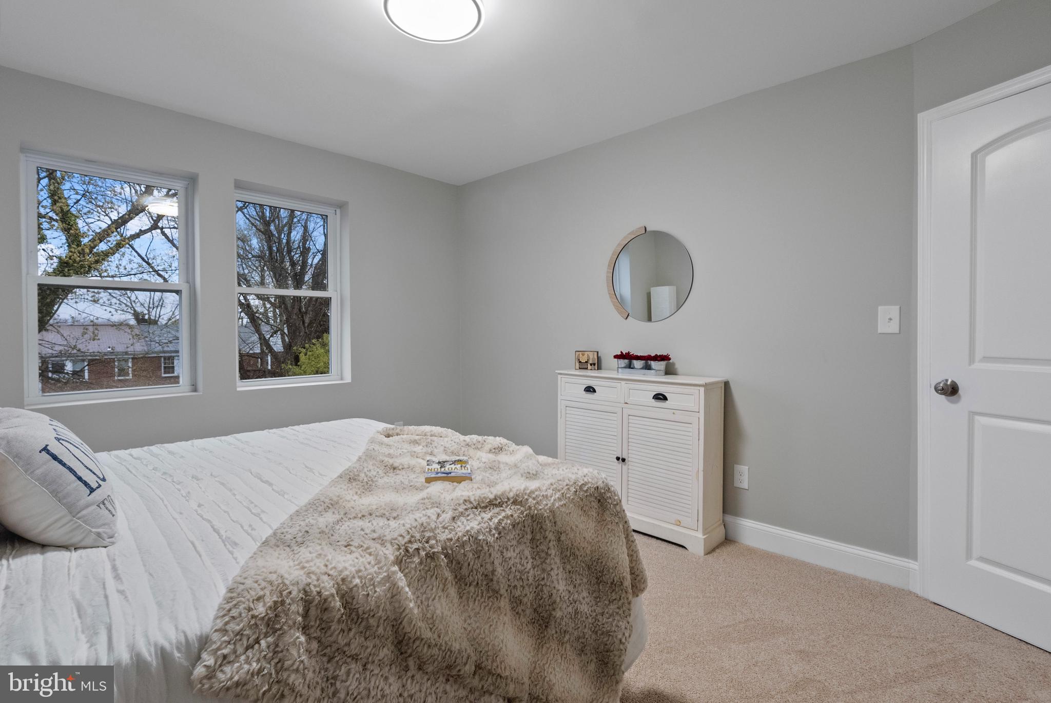 1641 Northwick Road Baltimore, MD 21218 - Photo 9 of 24 a bedroom with a white bed and a window