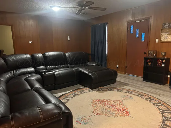 a bedroom with a bed and ceiling fan