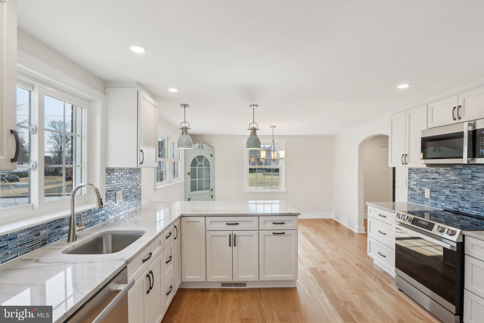 607 Fairview Road Swarthmore, PA 19081 - Photo 20 of 63 a kitchen with stainless steel appliances granite countertop a sink and a stove