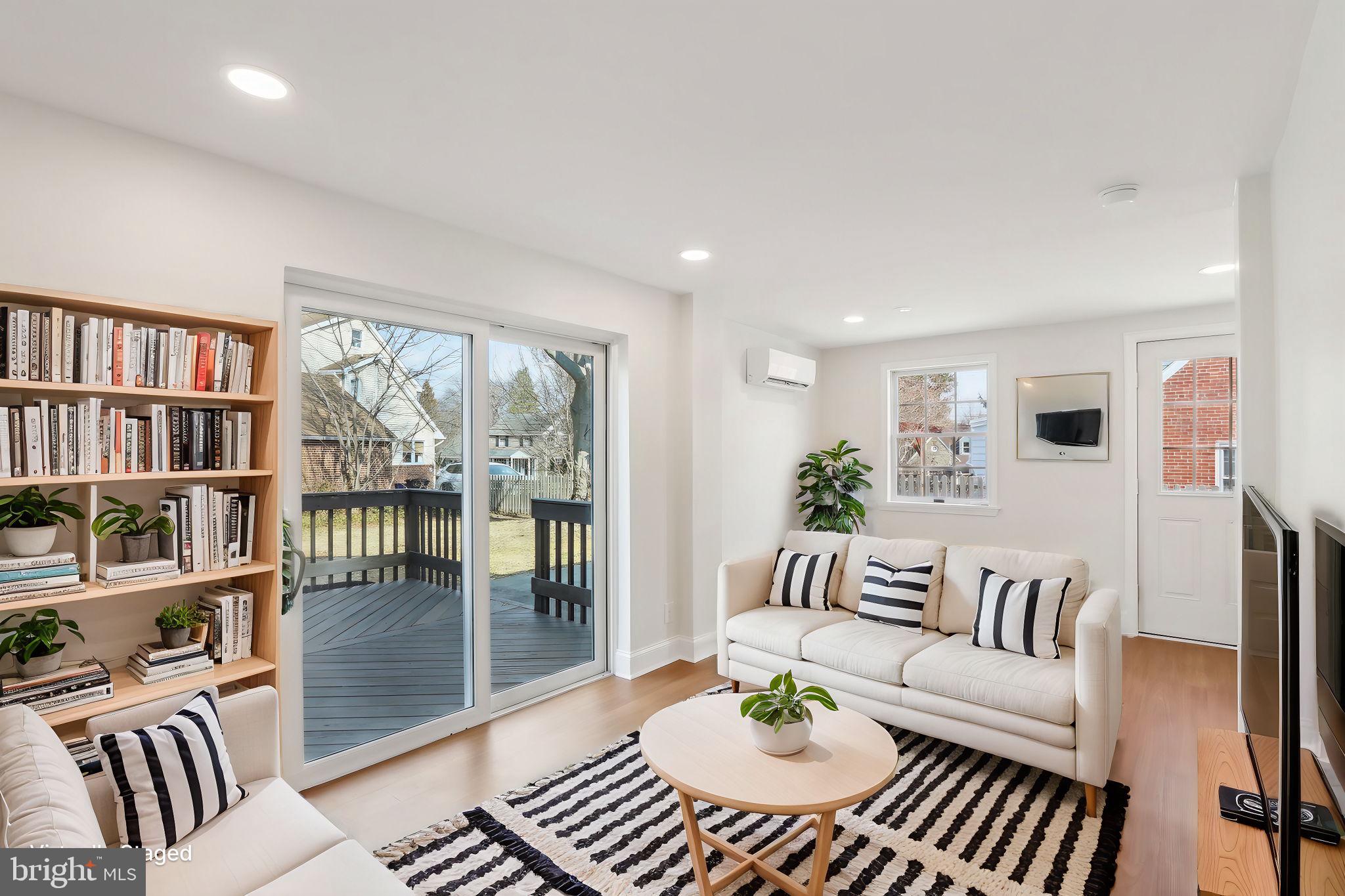 607 Fairview Road Swarthmore, PA 19081 - Photo 24 of 63 a living room with furniture a bookshelf and a book shelf