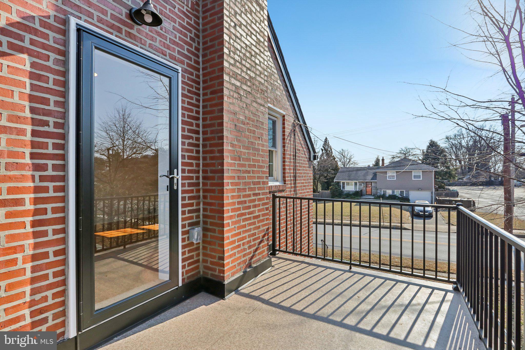 607 Fairview Road Swarthmore, PA 19081 - Photo 39 of 63 a view of a balcony with wooden floor and fence