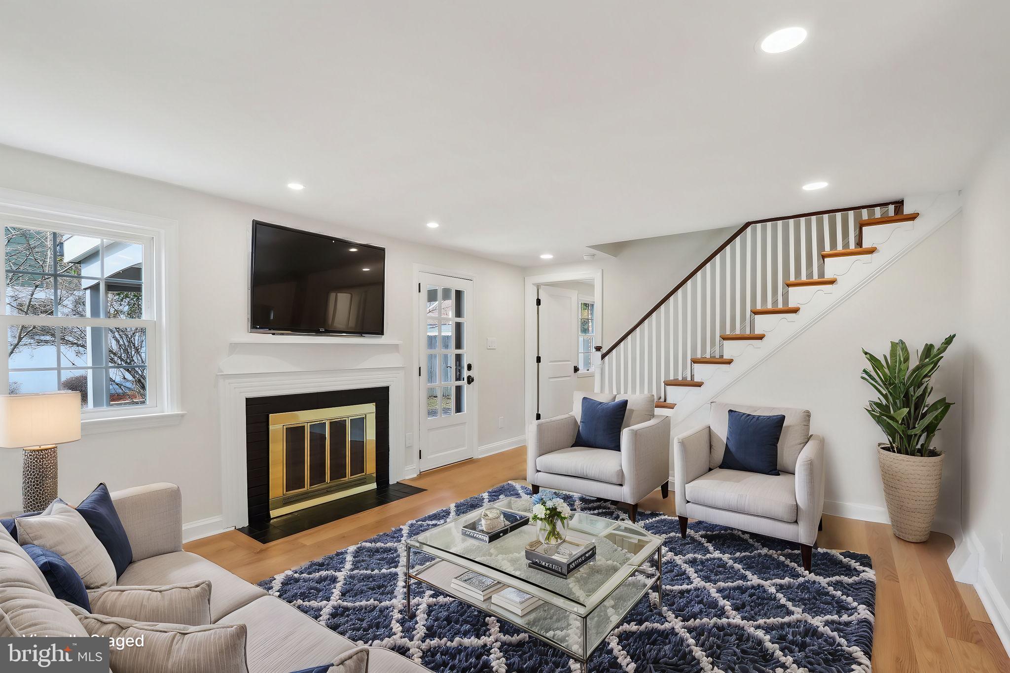 607 Fairview Road Swarthmore, PA 19081 - Photo 7 of 63 a living room with furniture a flat screen tv and a fireplace