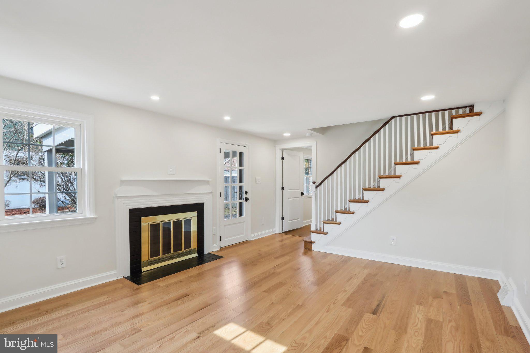 607 Fairview Road Swarthmore, PA 19081 - Photo 8 of 63 a view of an empty room with wooden floor fireplace and a window