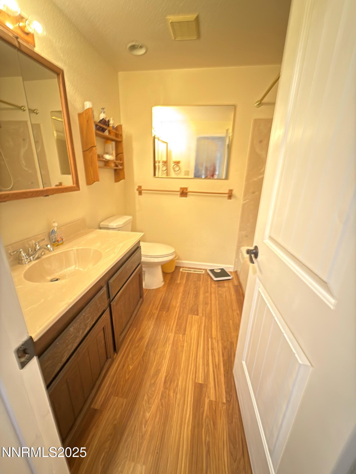 1537 Evan Street Carson City, NV 89701 - Photo 10 of 15 a bathroom with a sink a mirror and a toilet