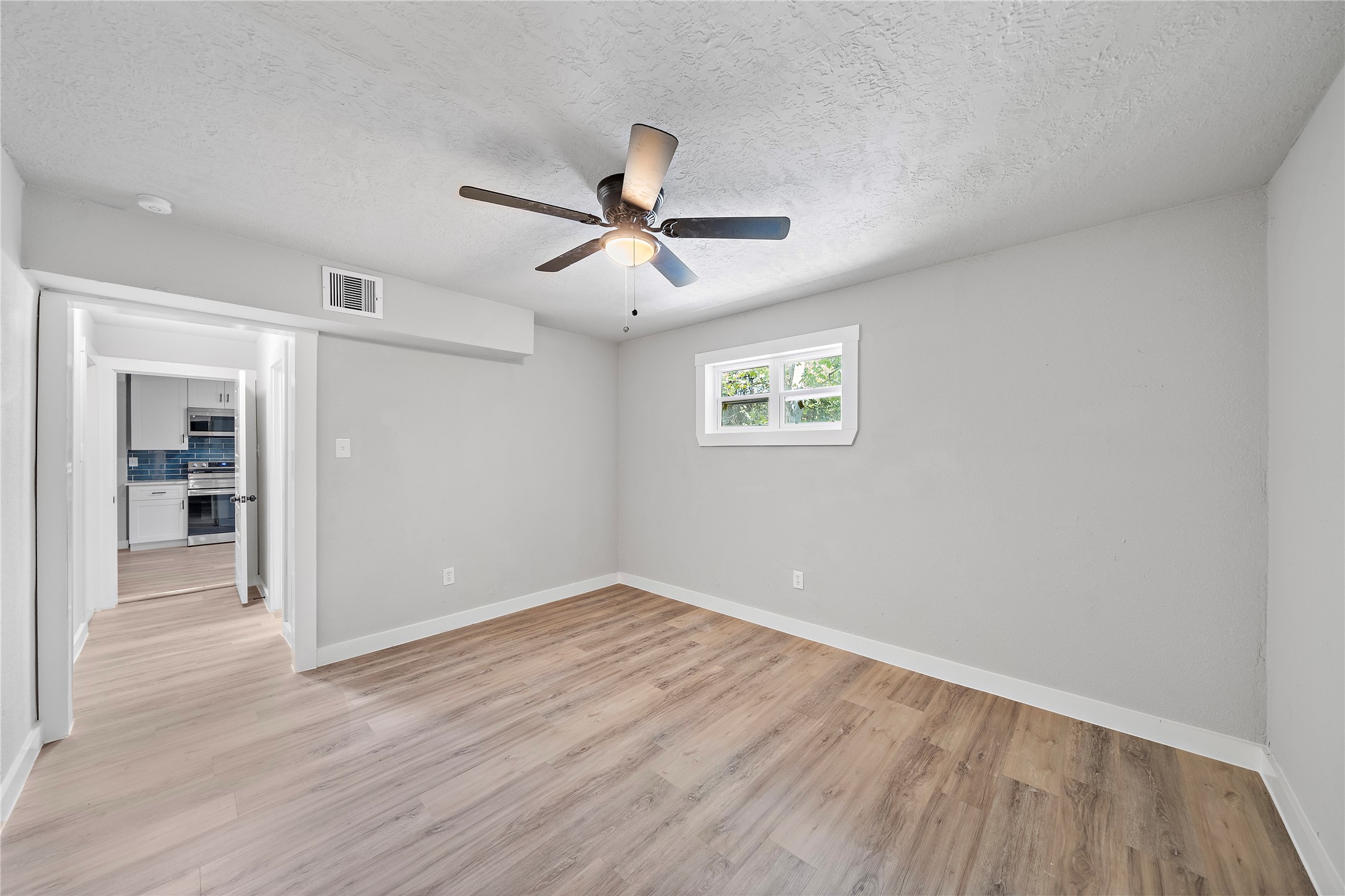 1004 West Harris Avenue Pasadena, TX 77506 - Photo 14 of 16 a view of empty room with wooden floor