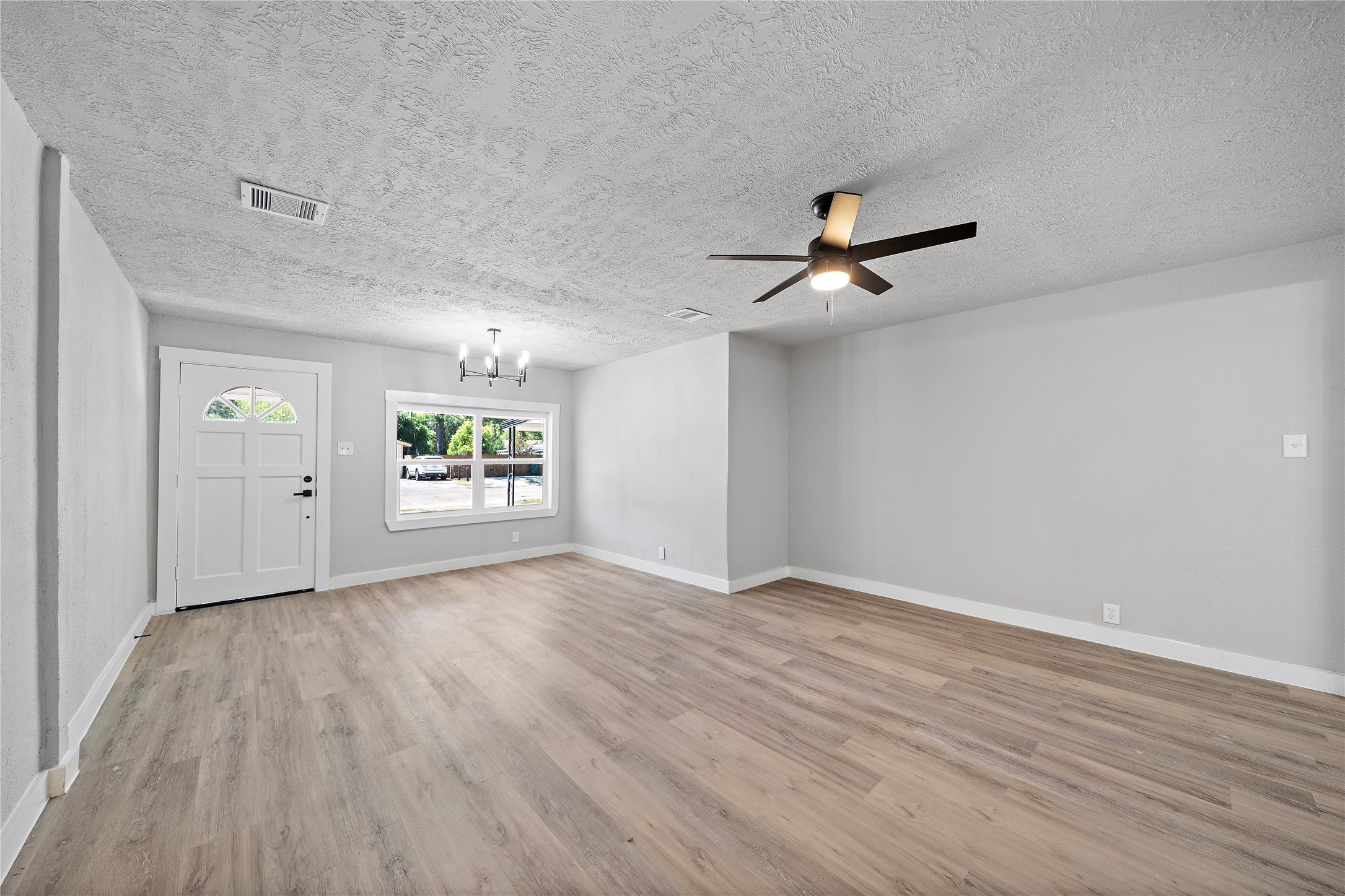 1004 West Harris Avenue Pasadena, TX 77506 - Photo 3 of 16 an empty room with window and wooden floor