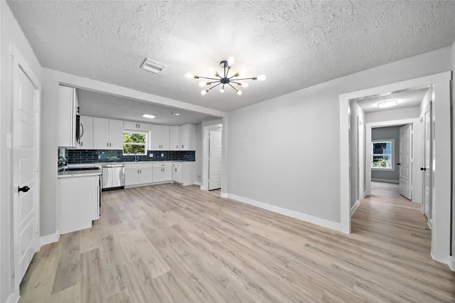 a view of kitchen with granite countertop cabinets and wooden floor