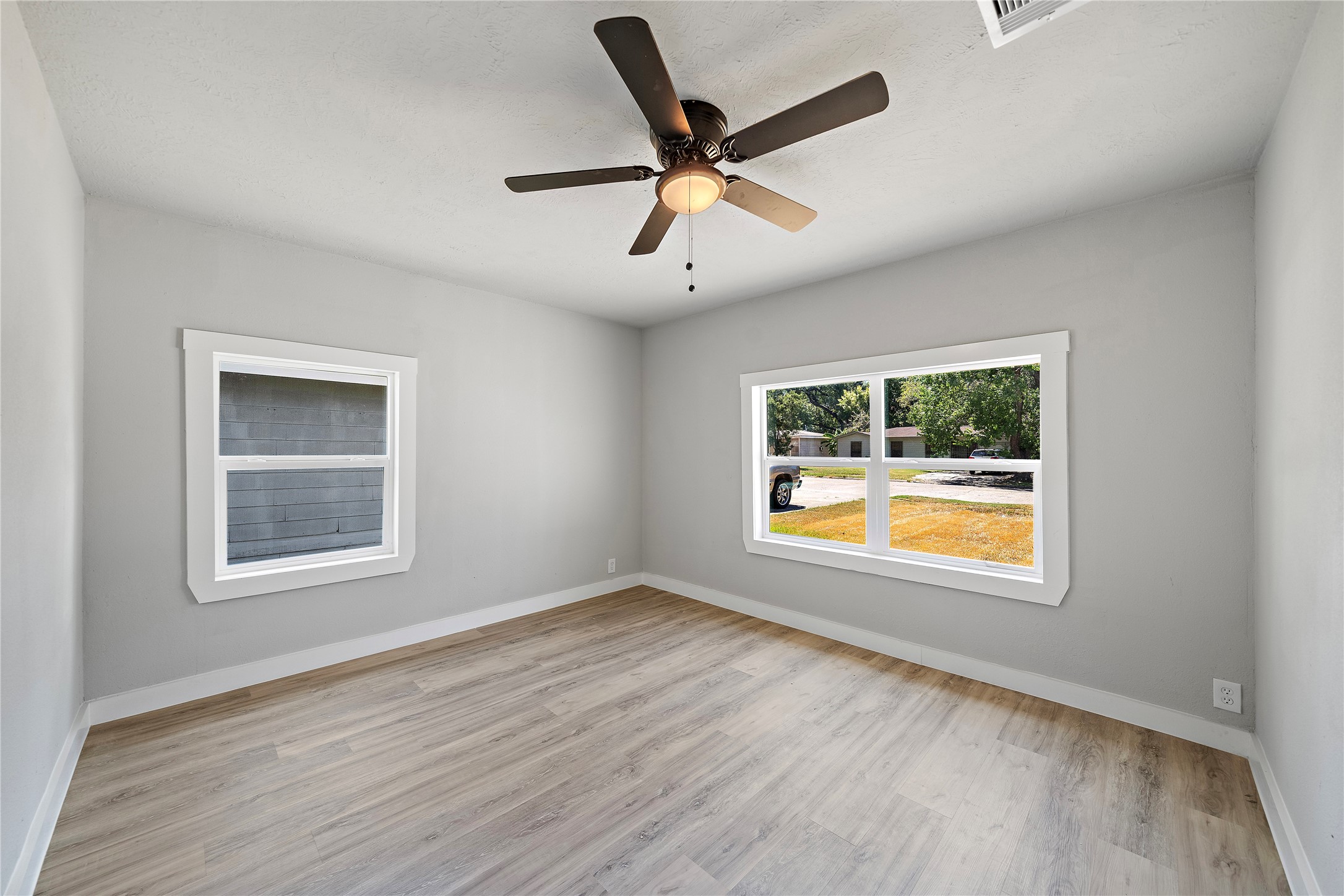 1004 West Harris Avenue Pasadena, TX 77506 - Photo 9 of 16 a view of an empty room with wooden floor and a window