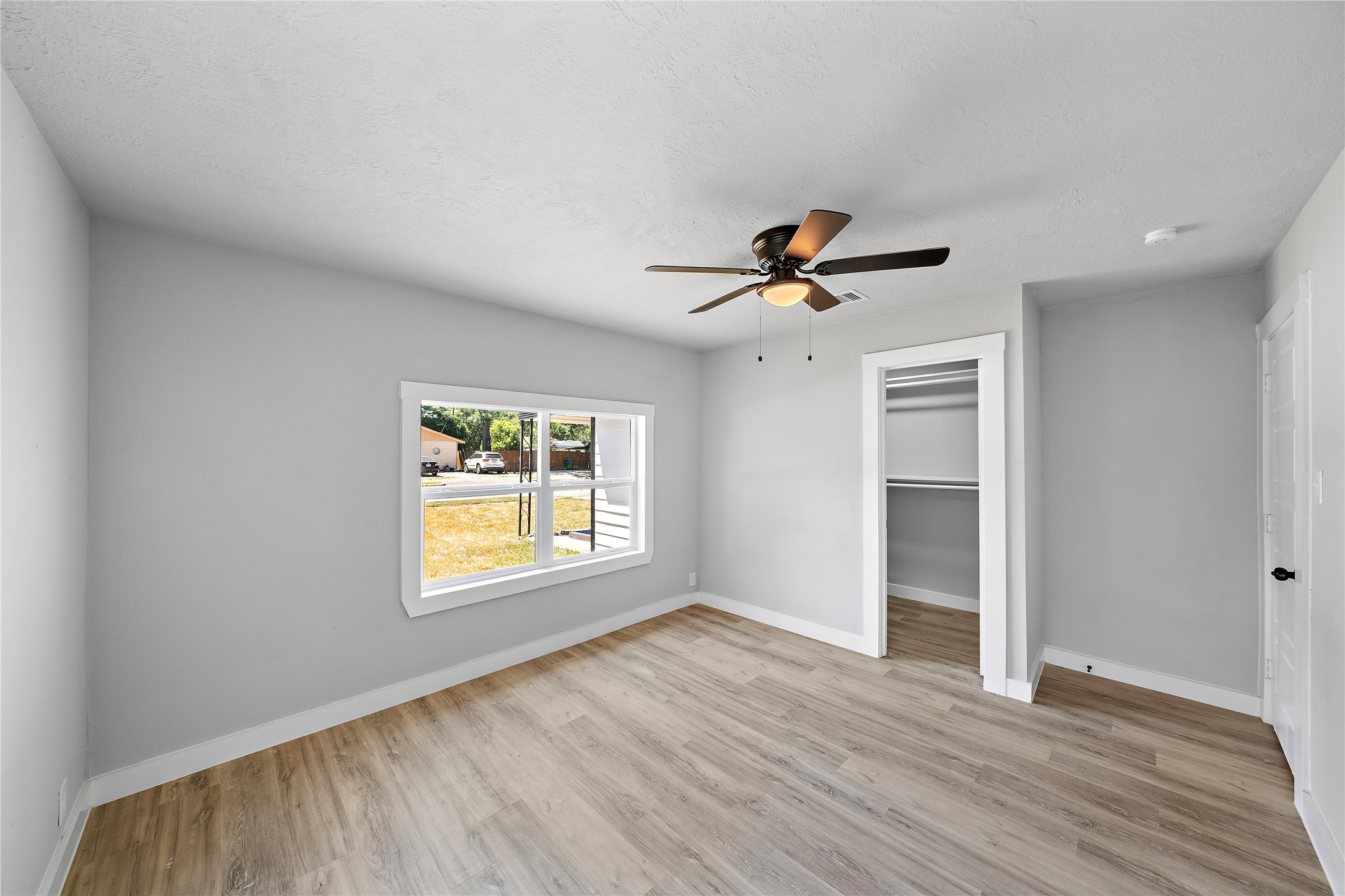 1004 West Harris Avenue Pasadena, TX 77506 - Photo 10 of 16 a view of empty room with wooden floor and fan