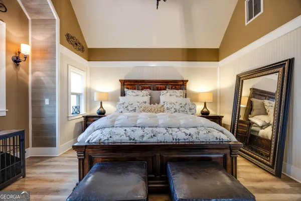 a bedroom with a bed and wooden floor