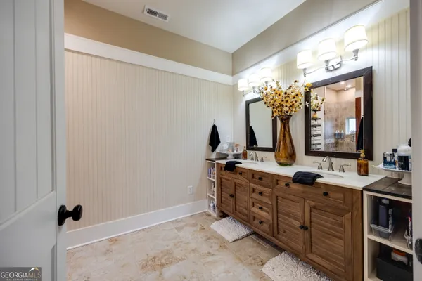 a bathroom with a double vanity sink and a mirror