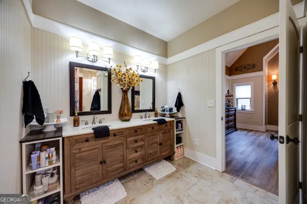 a bathroom with a double vanity sink and a mirror