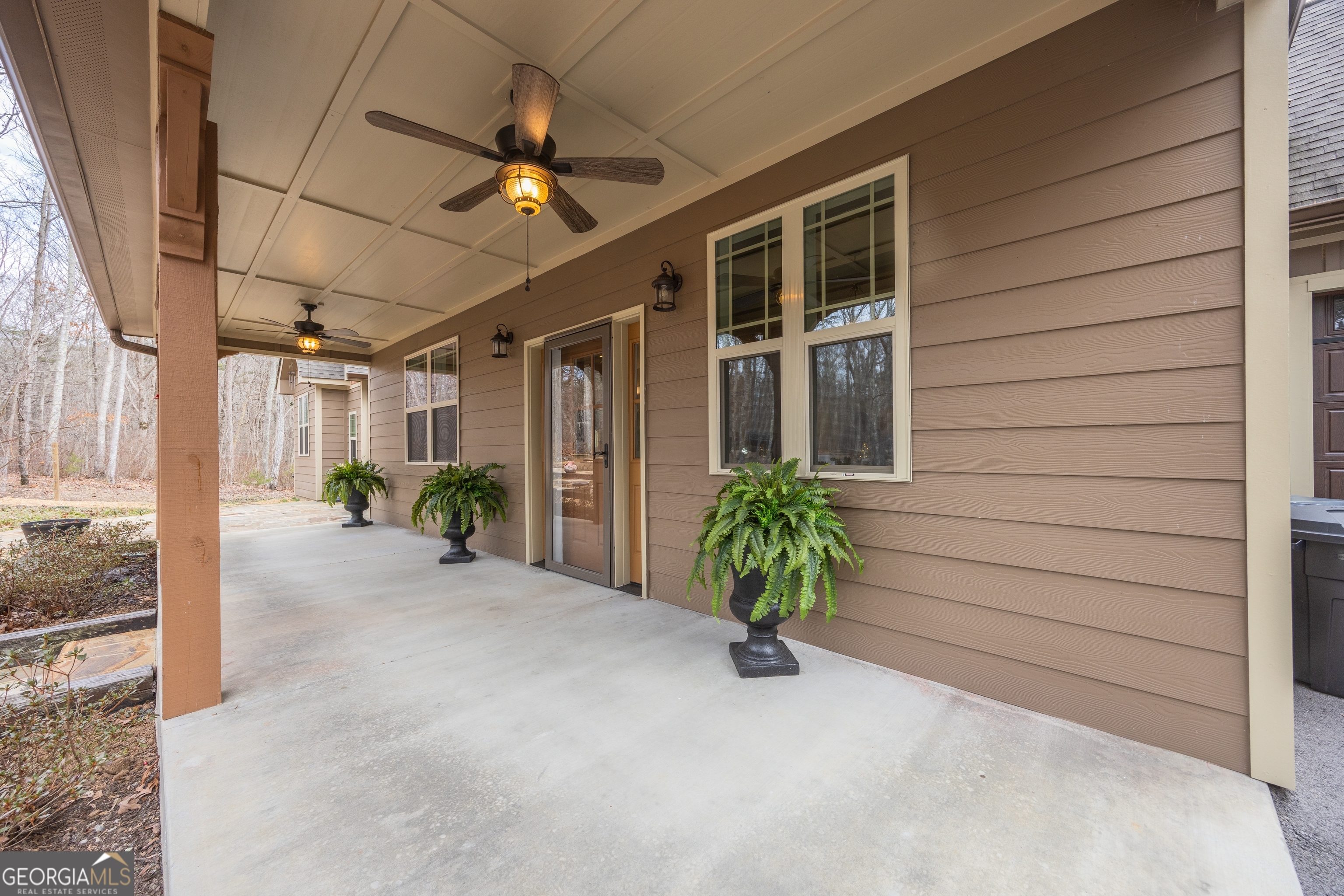 65 Eagle Bluff Road Menlo, GA 30731 - Photo 2 of 42 a view of a porch with a table and chairs under an umbrella