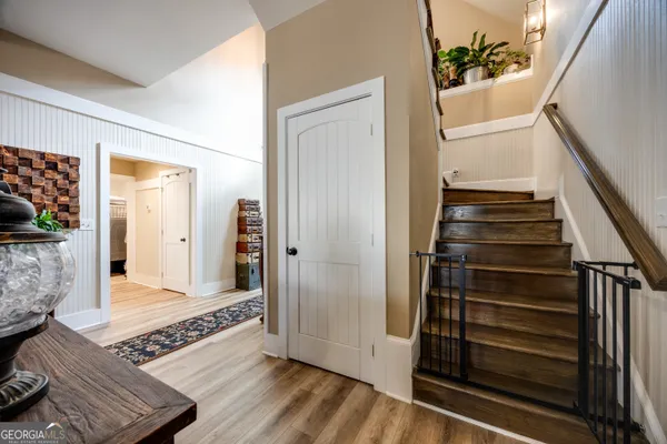 a view of an entryway with wooden floor and stairs