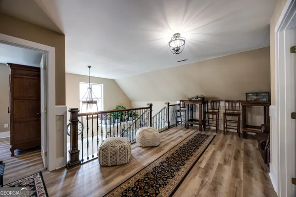 a bedroom with furniture and a wooden floor