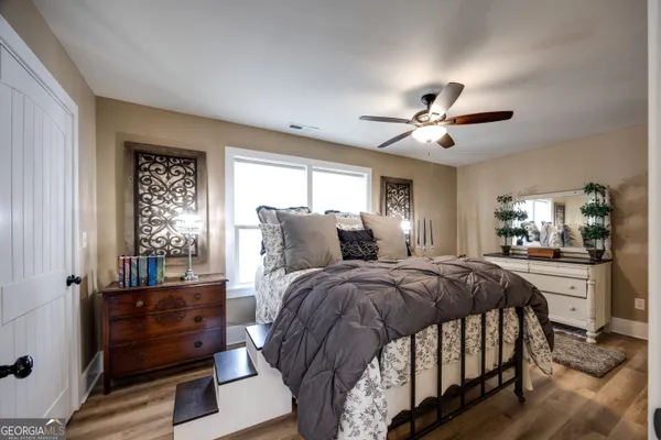 a bed room with a bed and a chandelier