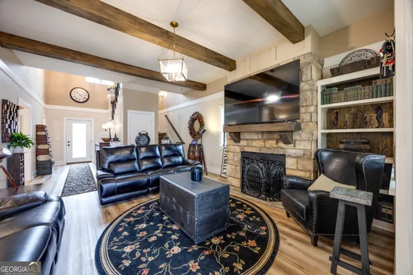 a living room with furniture a flat screen tv and a fireplace
