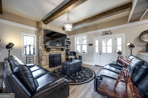 a living room with furniture fireplace and a flat screen tv