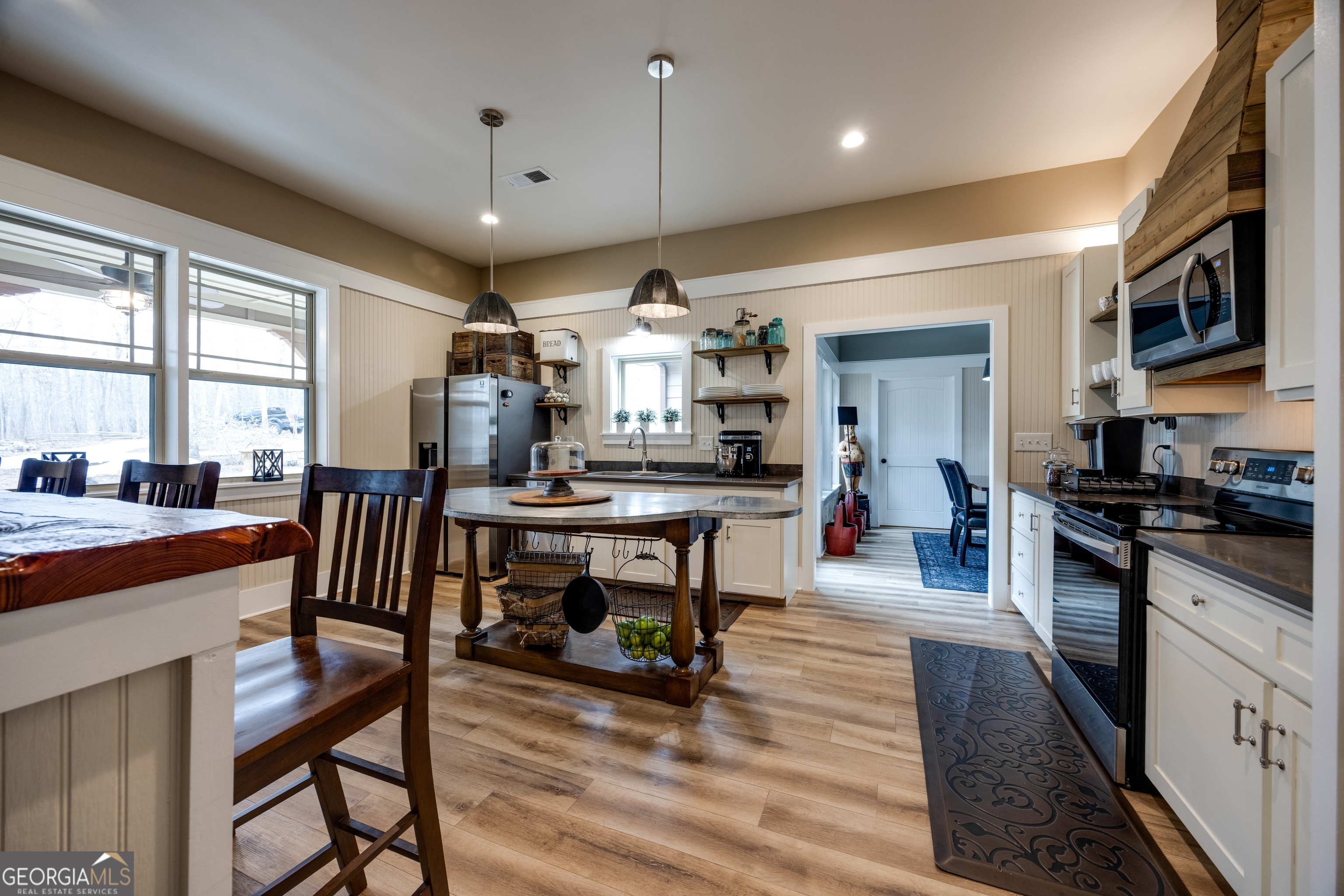 65 Eagle Bluff Road Menlo, GA 30731 - Photo 6 of 42 a kitchen with stainless steel appliances granite countertop a stove a sink dishwasher a dining table and chairs with wooden floor