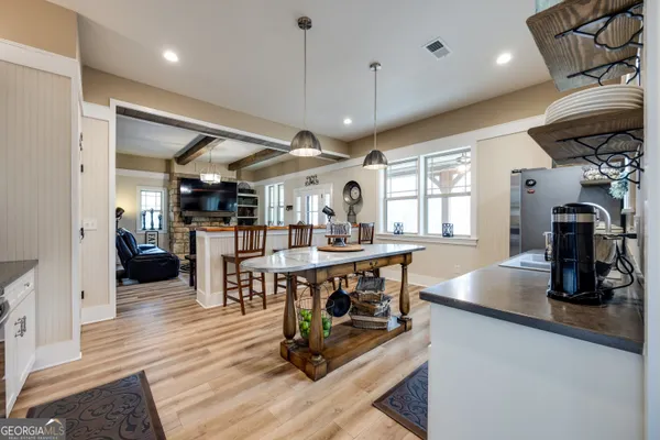 a view of a dining room with furniture and wooden floor